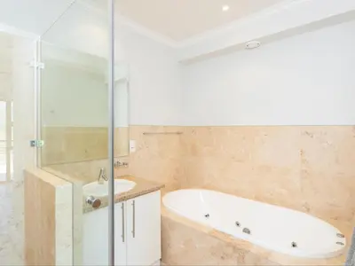 a bathroom with a tub and a sink at Luxury Lodge 5B, Pearl Valley Golf Estate in Simondium