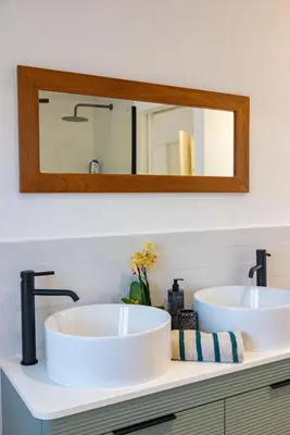 two sinks on a bathroom counter with a mirror at Onrus Island Milkwood Sanctuary in Hermanus