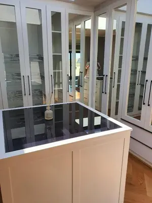 a room with glass cabinets and a counter top at Classy 3 storey house in Gordonʼs Bay