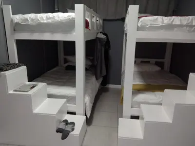 two bunk beds in a small room with twounks at Star legend backpackers - Parow in Parow