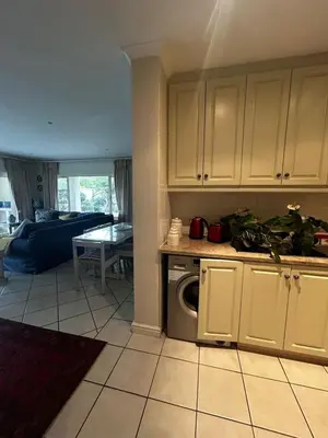 a kitchen and living room with a washer and dryer at 16 on Fernkloof in Hermanus