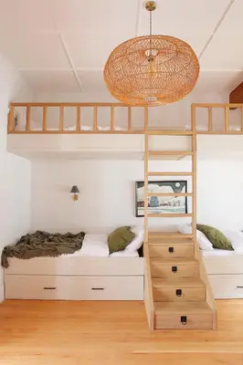 a bedroom with two bunk beds and a chandelier at Hermanus Seafront Villa - Sophie's Rock in Hermanus