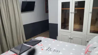 a room with a white table and a white cabinet at Shalom Batchelor in Strand