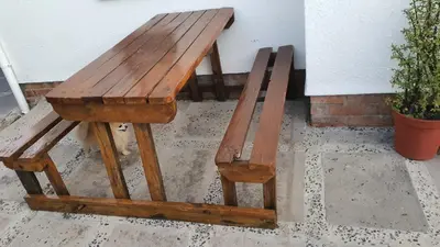 a wooden bench sitting next to a wall at Shalom Batchelor in Strand