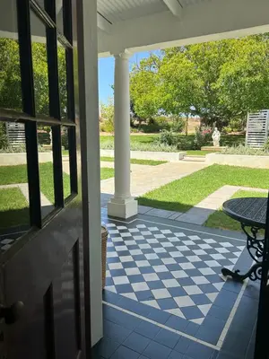 a porch with a table and a view of a yard at Rooiheuwel in Botrivier