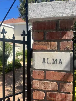 a brick wall with a sign that reads alma at The Alma House 1900 in Cape Town