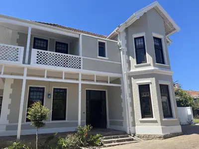 a white house with a balcony at The Alma House 1900 in Cape Town