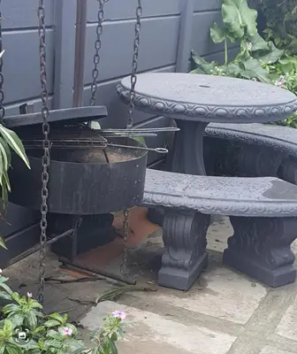 a swing and a table on a porch at Shalom Batchelor in Strand