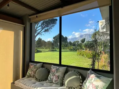 a large window with a couch in front of it at The Cottage - a tranquil hideaway in Somerset West