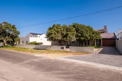 an empty street in front of a house at Lawaaiwaters in Hermanus