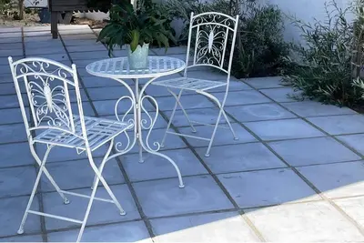 two chairs and a table on a patio at Little Nest Self-Catering in Hermanus