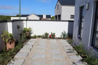 a stone walkway in front of a house at Little Nest Self-Catering in Hermanus