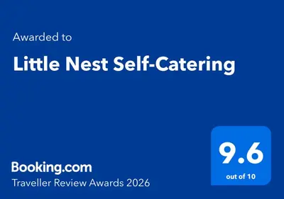 a blue sign that says little nest self self catering at Little Nest Self-Catering in Hermanus