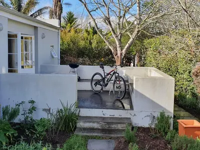 a bike parked on the side of a house at Charming Rose Cottage in Greyton