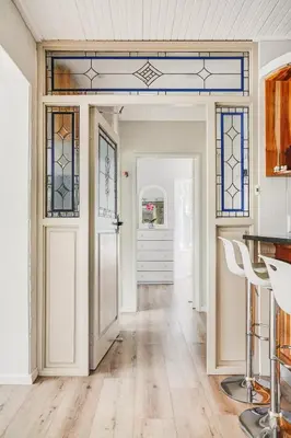 an open hallway with a door and stained glass windows at Villa Franlisa in Hermanus