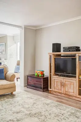 a living room with a television and a couch at Villa Franlisa in Hermanus