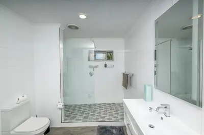a bathroom with a shower and a toilet and a sink at Infinite Studio str in Panorama