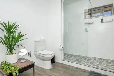 a bathroom with a toilet and a shower at Infinite Studio str in Panorama