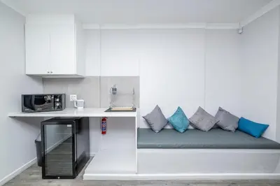 a couch with pillows on it in a kitchen at Infinite Studio str in Panorama