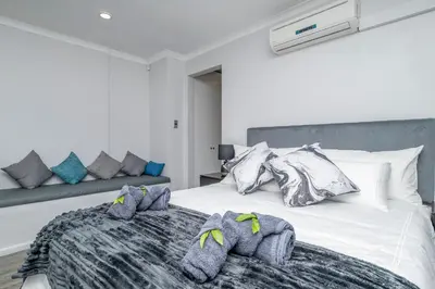a bedroom with a bed with towels on it at Infinite Studio str in Panorama