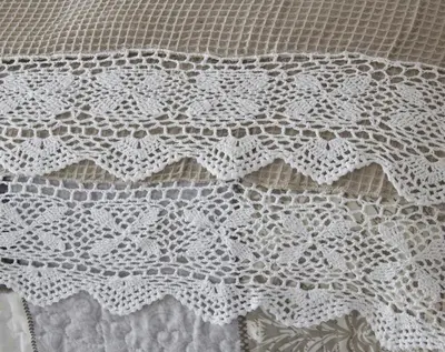 a close up of a bed with a white lace curtain at De Kleine Herberg in Durbanville