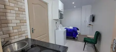 a bathroom with a sink and a room with a bed at Twinex Accommodation Parow in De Grendel
