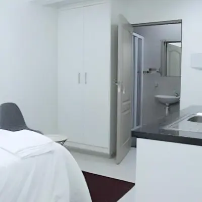 a white room with a sink and a bathroom at Twinex Accommodation Bellville in Stikland