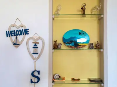 a shelf with a welcome sign and a heart shaped mirror at Golfbeach Luxury self catering apartment in Cape Town