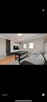 a living room with a pool table and a couch at YA Eagle Wings Self Catering Shared Single Room Lodge A in Cape Town