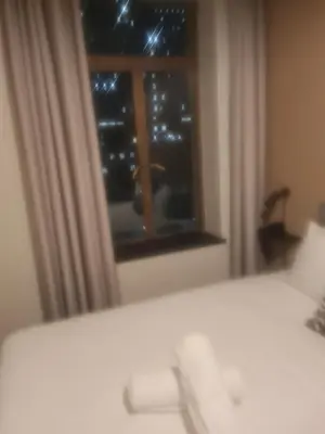 a bedroom with a window looking out at the stars at Mikasa Cukasa Geust House in Gordonʼs Bay