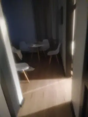 a view of a room with a table and chairs at Mikasa Cukasa Geust House in Gordonʼs Bay