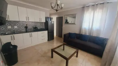 a living room with a couch and a table at Zoe Apartment in Cape Town