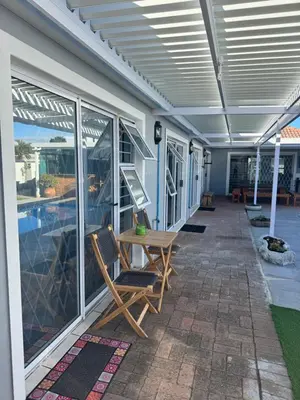 a patio with a table and chairs on a house at Pemba Guest Cape Town in Cape Town