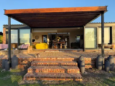a house with a brick staircase leading to a patio at EersteBosch Cottages in Stellenbosch
