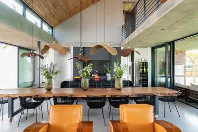 a large dining room with a large wooden table and chairs at EersteBosch Cottages in Stellenbosch