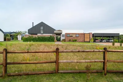 a wooden fence in front of a house at EersteBosch Cottages in Stellenbosch