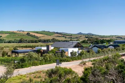 a road leading to a farm with at EersteBosch Cottages in Stellenbosch