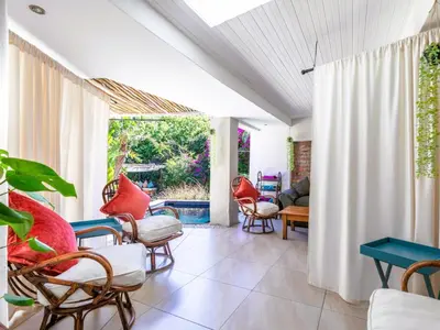 a living room with chairs and a table at Absolute Bosch Guest House in Stellenbosch