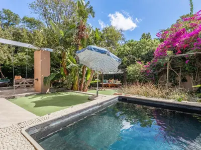 a swimming pool in a yard with a golf course at Absolute Bosch Guest House in Stellenbosch