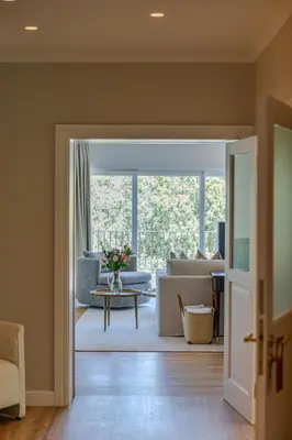 a living room with a couch and a table at The Helderview Luxury Suites in Somerset West