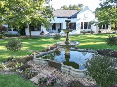 a fountain in the yard of a house at Vendome Wine Estate in Paarl