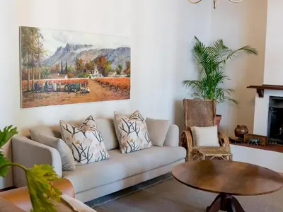 a living room with a couch and a table at Vendome Wine Estate in Paarl