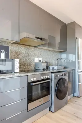 a kitchen with a washer and dryer in it at Lifestyle Accommodation in Cape Town