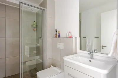 a bathroom with a toilet and a sink and a shower at Lifestyle Accommodation in Cape Town