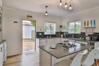 a kitchen with a large island in the middle at Casa Mia in Hermanus