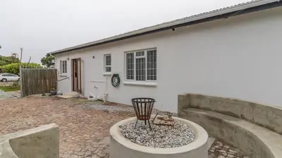 a white house with a bird bath in front of it at Casa Mia in Hermanus