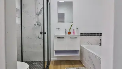 a white bathroom with a shower and a sink at Casa Mia in Hermanus
