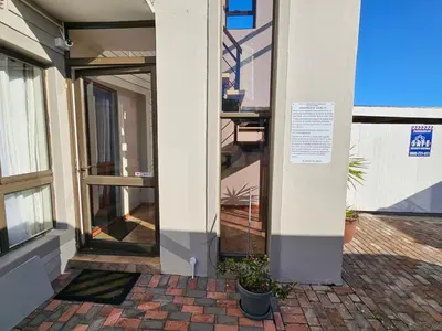 a front door of a building with a sign on it at Vues Du Mont in Hermanus