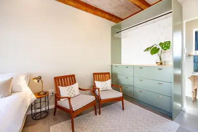 two chairs in a bedroom with a bed and a dresser at Lily's Pad in Oakdale