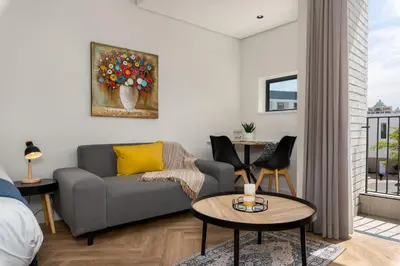 a living room with a couch and a table at On Park Apartments in Cape Town